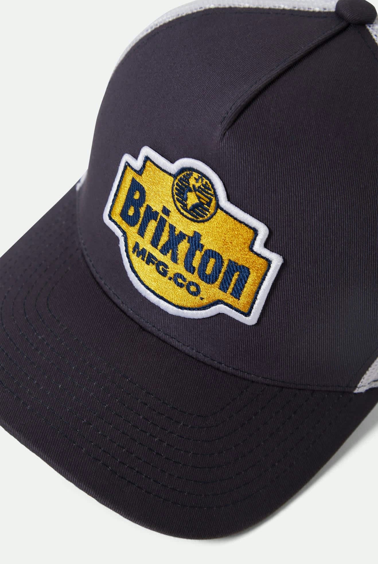 Unisex Genuine Quality Netplus Trucker Hat in the color Mood Indigo/White - Additional Laydown image