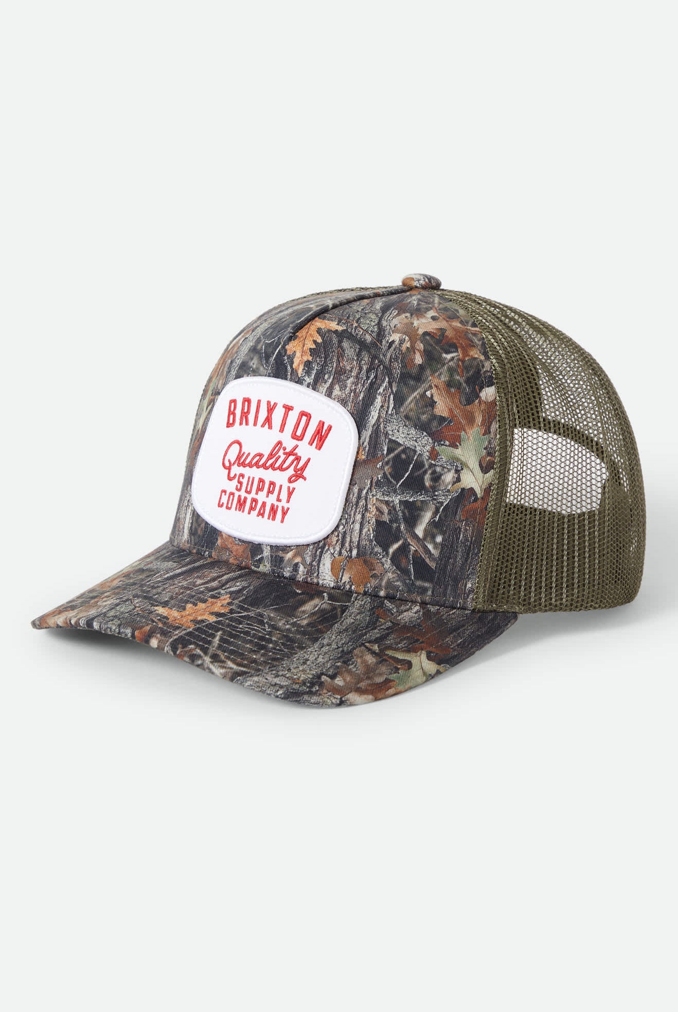 Unisex Hubal Netplus Trucker Hat in the color Tree Camo/Olive - Front Product Laydown Image