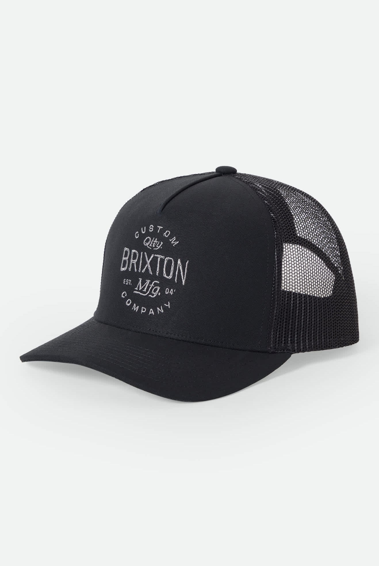 Unisex Fremont Netplus Trucker Hat in the color Black/Black - Front Product Laydown Image