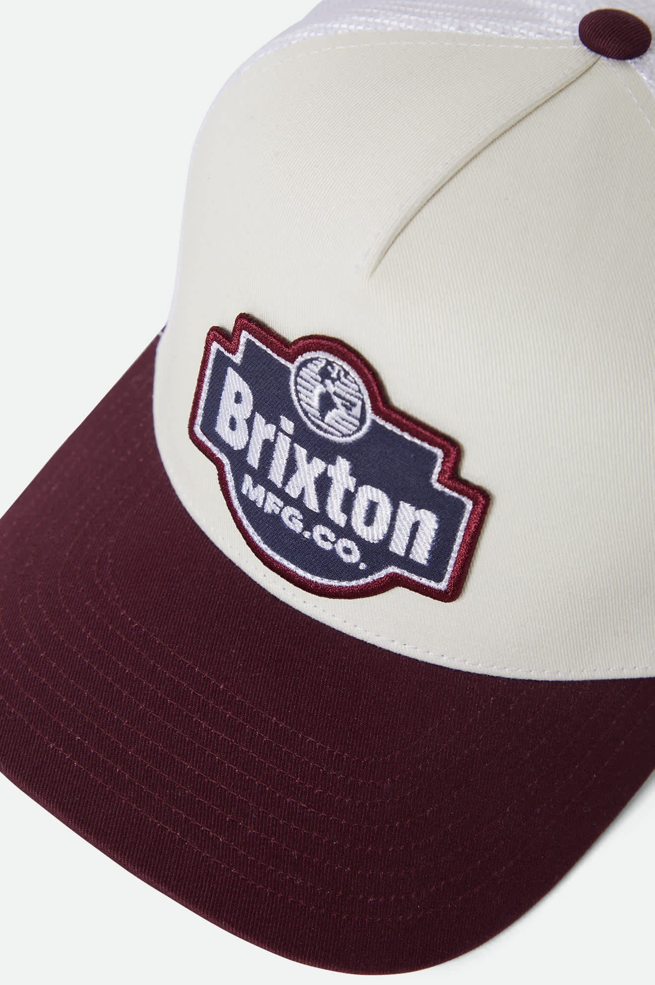 Unisex Genuine Quality Netplus Trucker Hat in the color Off White/Port - Additional Laydown image