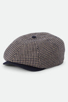 Unisex Brood Newsboy Cap in the color Navy/Sand Houndstooth - Front Product Laydown Image