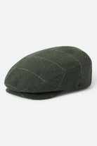 Unisex Hooligan Flat Cap in the color Moss/Orange - Front Product Laydown Image